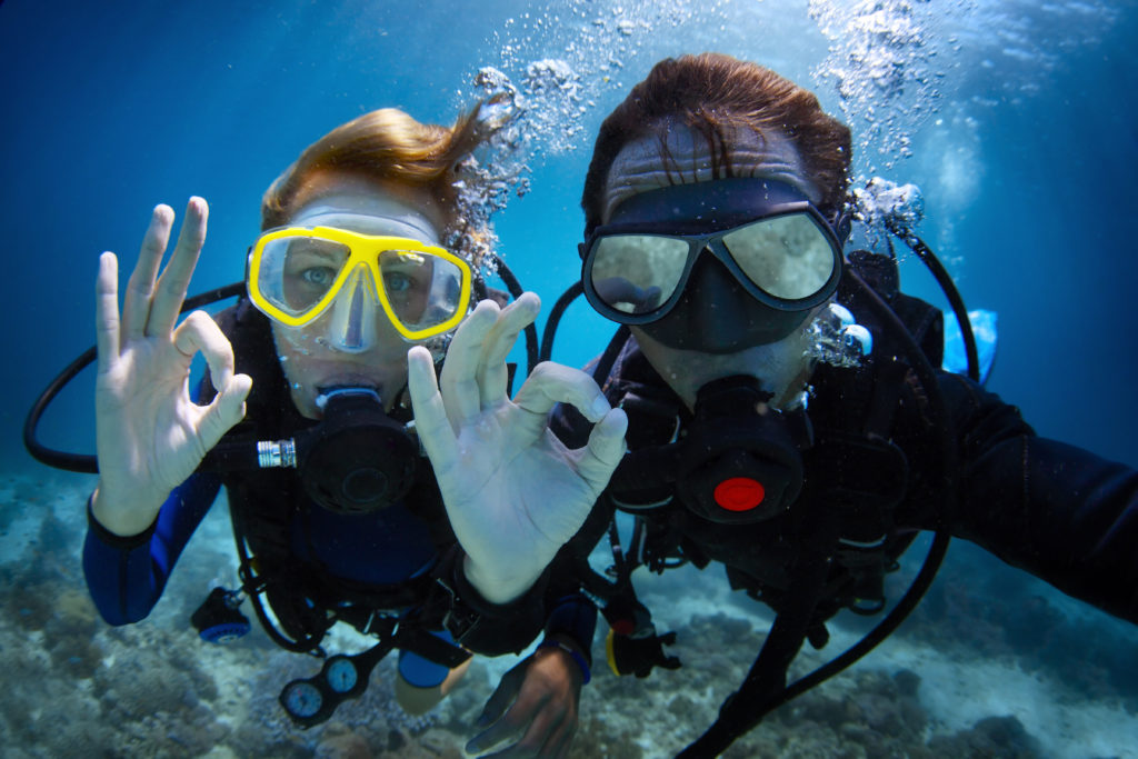 Two Scuba Divers Taking A Photo
